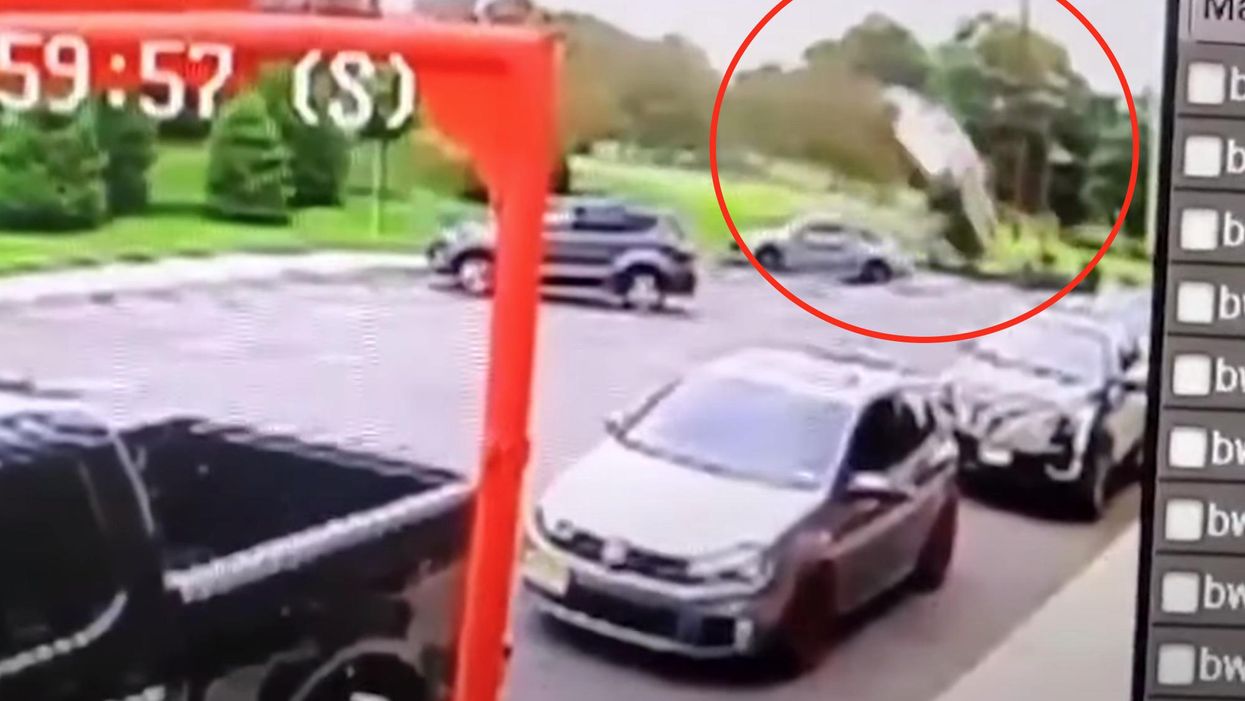 Security video captures the moment a car goes airborne and crashes feet away from a family eating at Wendy's