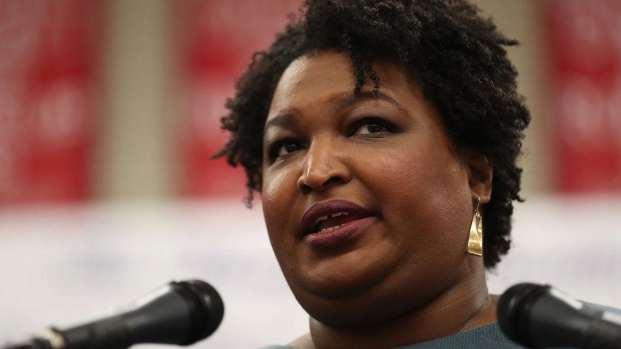 Stacey Abrams deletes photo of herself grinning unmasked in a classroom surrounded by young children forced to wear masks after being called out for breaking mask mandate