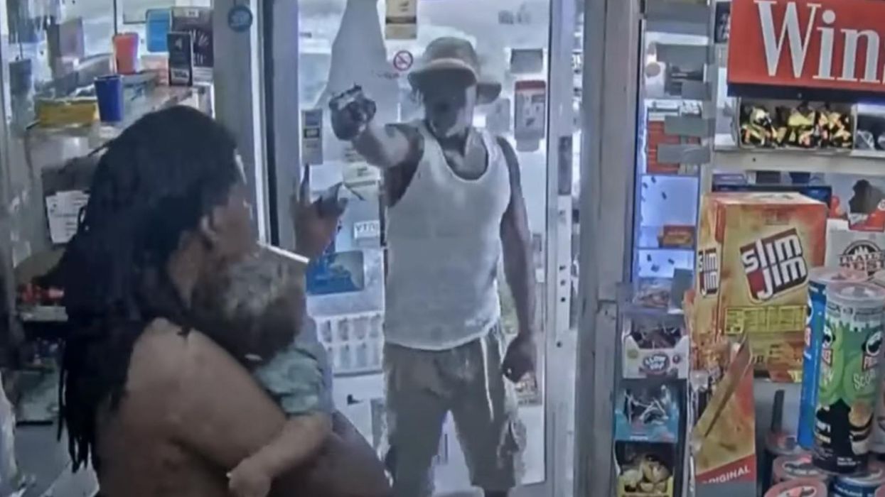 'Chilling' video shows a man pulling a gun on another man holding his baby. Police say the gun jammed.