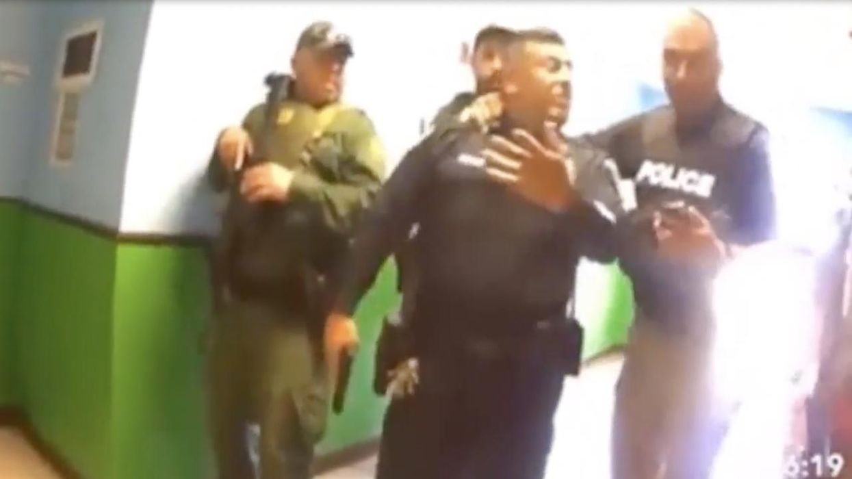 Bodycam video shows police officer husband of elementary teacher shot in Uvalde being held back from apparently trying to rescue her amid mass killing