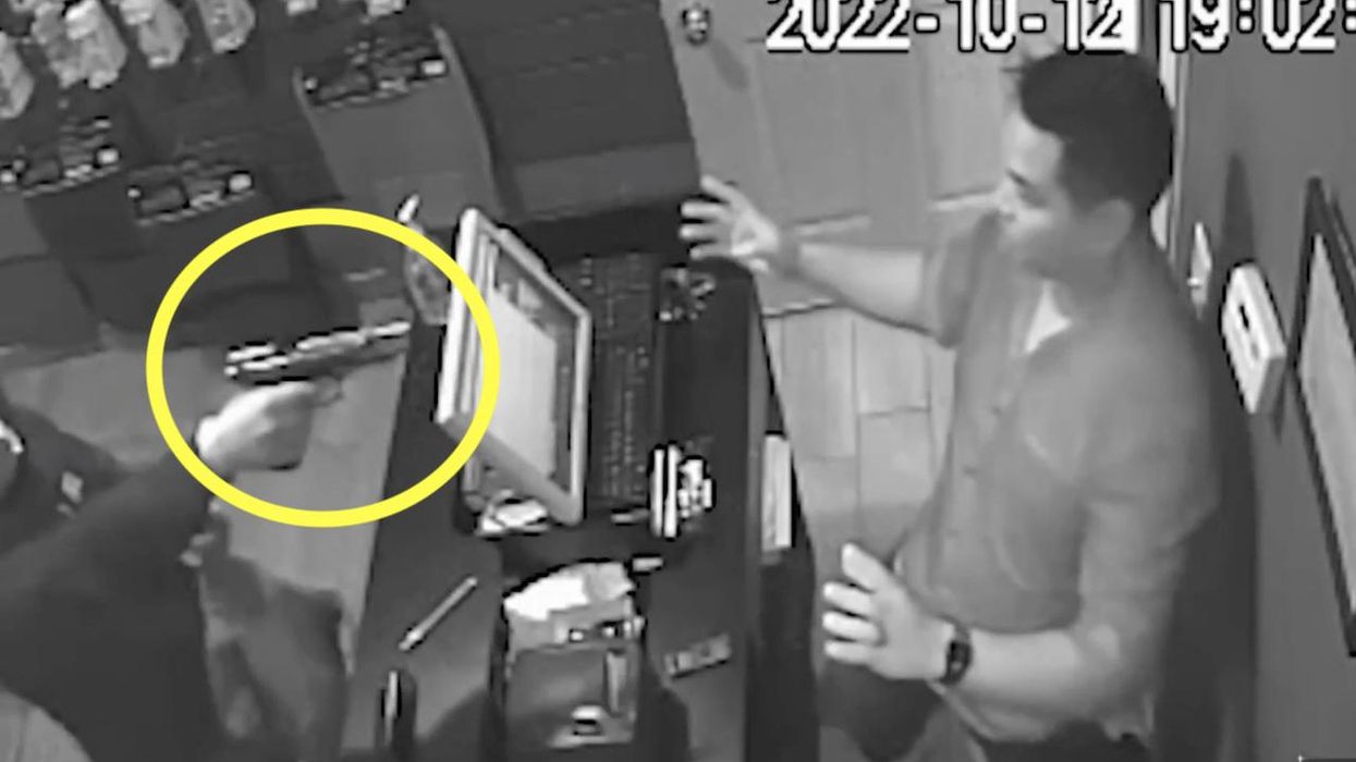 Masked crook points gun at Chicago business owner, who's in 'complete shock.' But when perp has trouble with pistol, victim seizes moment to fight back.