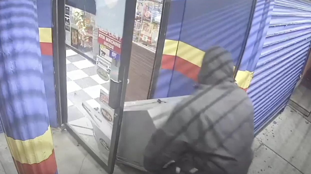 Gun-toting masked thug threatens worker inside Philly deli while his accomplice drags out their prize — an ATM