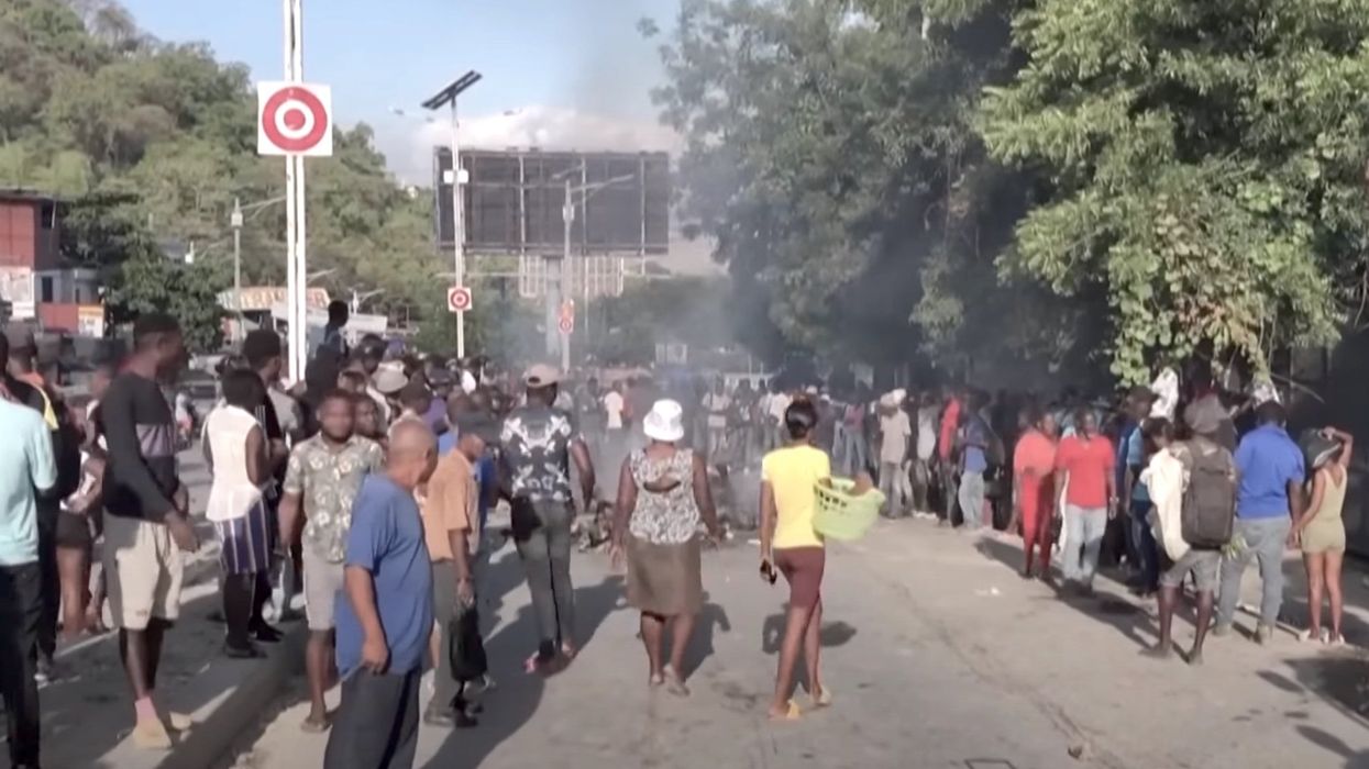 Vigilante mob burns 13 gang members to death with gas-soaked tires in the streets of Haiti's capital
