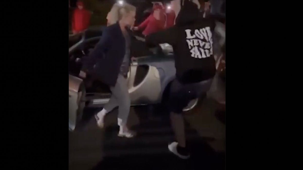 Video: Thug repeatedly kicks woman's car amid violent street takeover — but message on his hoodie may be saddest part