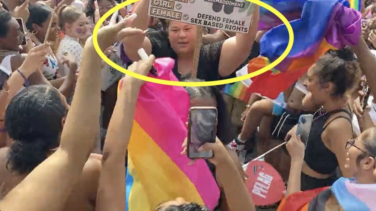 Scary video: Pro-LBGTQ mob gangs up on, gets physical with lone woman holding sign defending female rights
