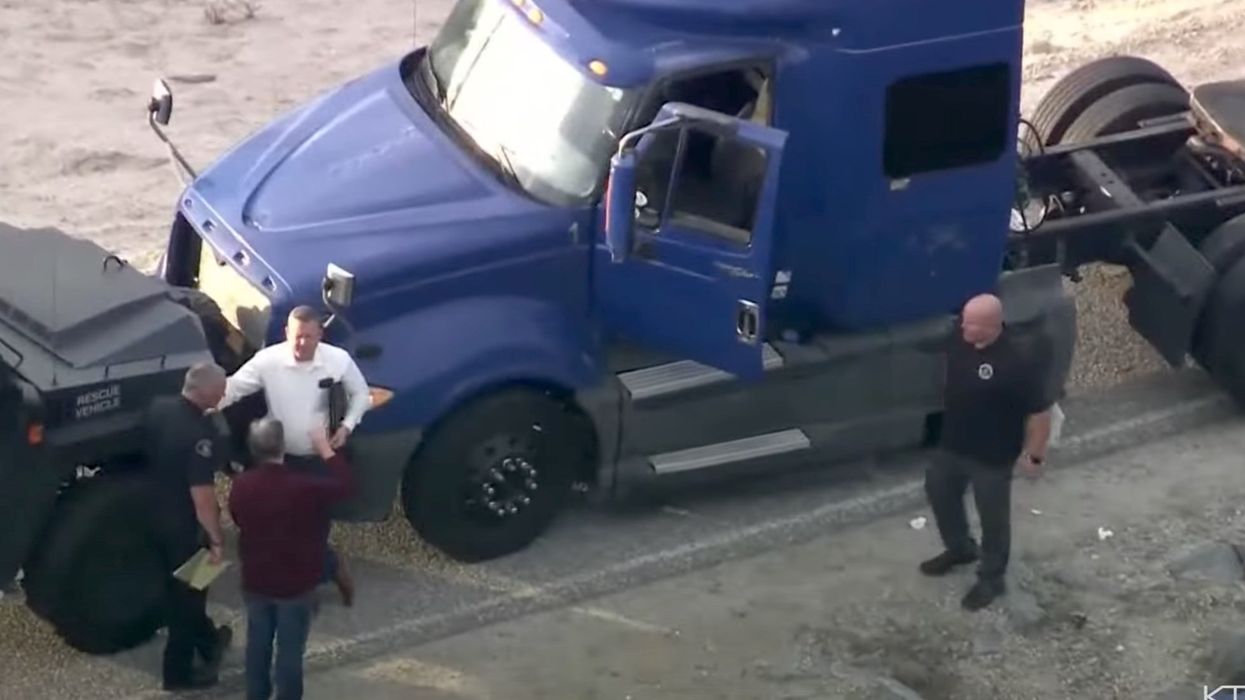 Police on manhunt for suspect who allegedly rammed patrol car with stolen big rig and fled as police shot at him