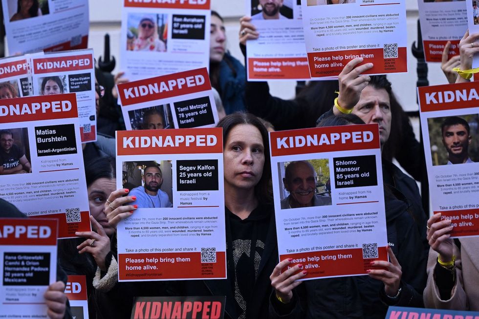 Israel approves deal to release Palestinian prisoners and pause military action in exchange for dozens of hostages