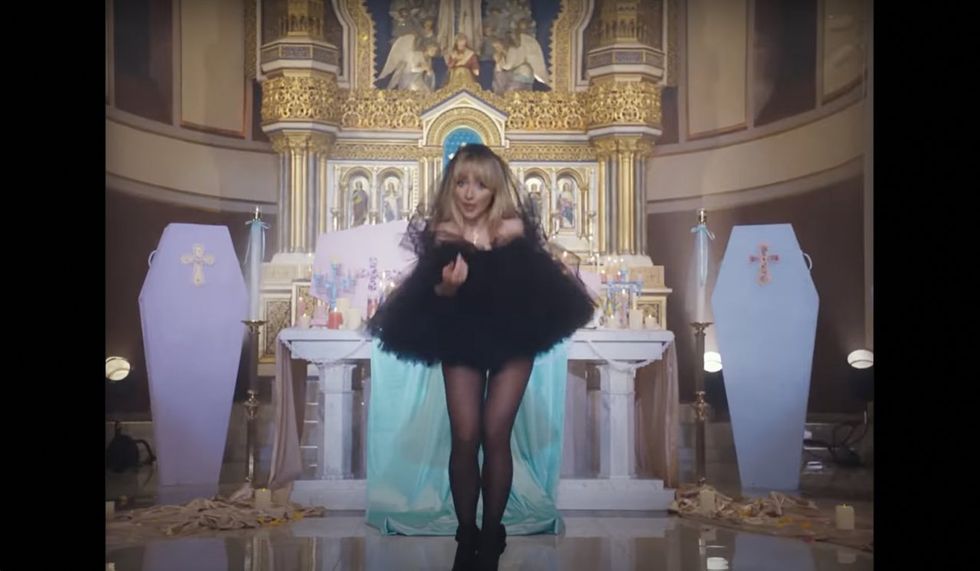 'Jesus was a carpenter': Pop singer unrepentant over racy video shot in Catholic church. Priest who OK'd shoot is punished.