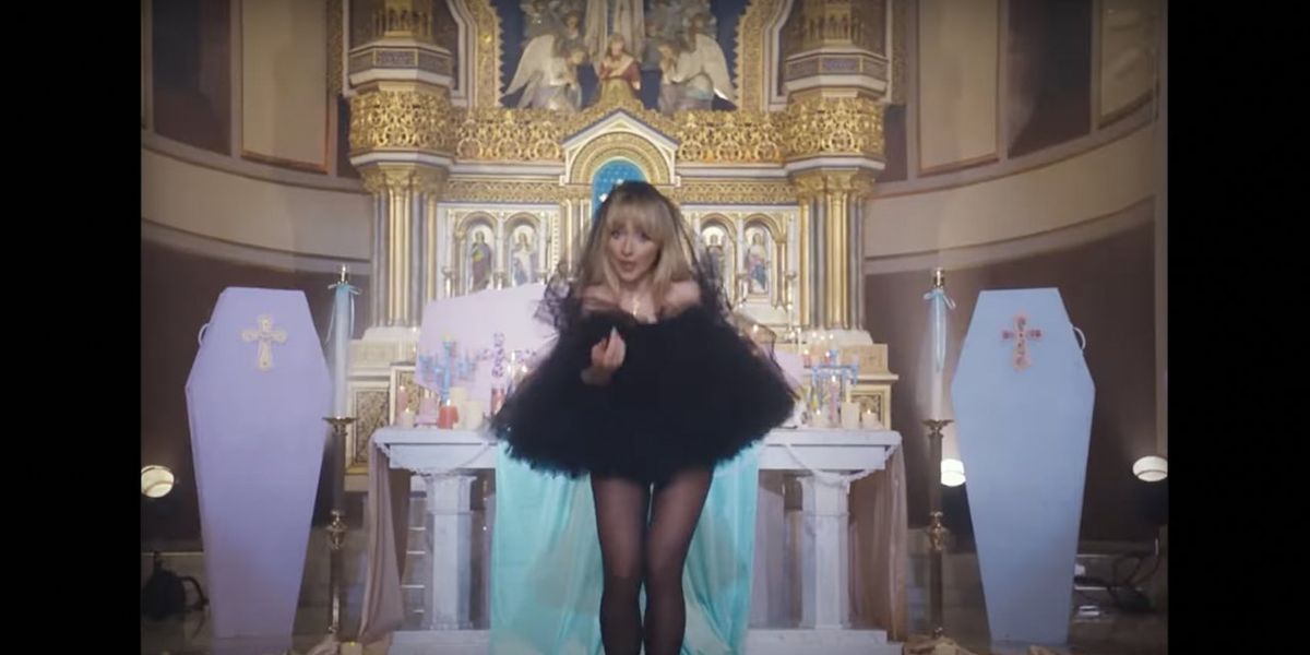 NextImg:'Jesus was a carpenter': Pop singer unrepentant over racy video shot in Catholic church. Priest who OK'd shoot is punished. | Blaze Media