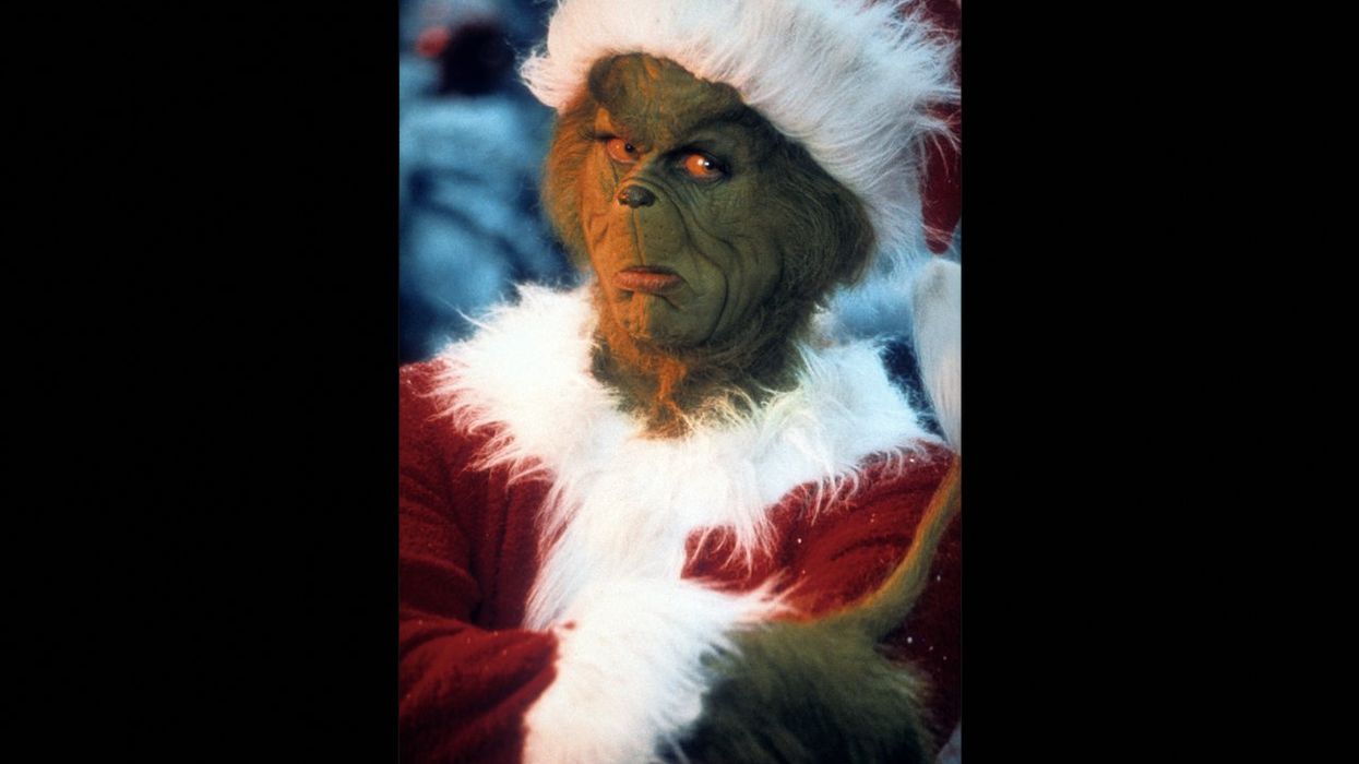 'Grinch' holds sign reading 'Santa is fake, Jesus is real' outside elementary school. One dad doesn't like that very much.