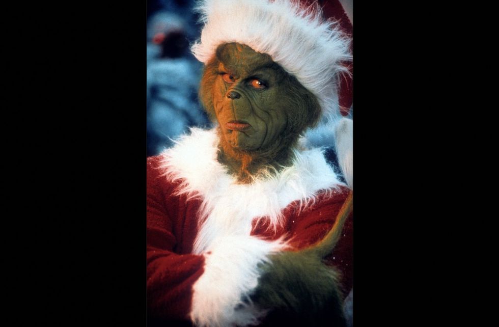 'Grinch' holds sign reading 'Santa is fake‚ Jesus is real' outside elementary school. One dad doesn't like that very much.