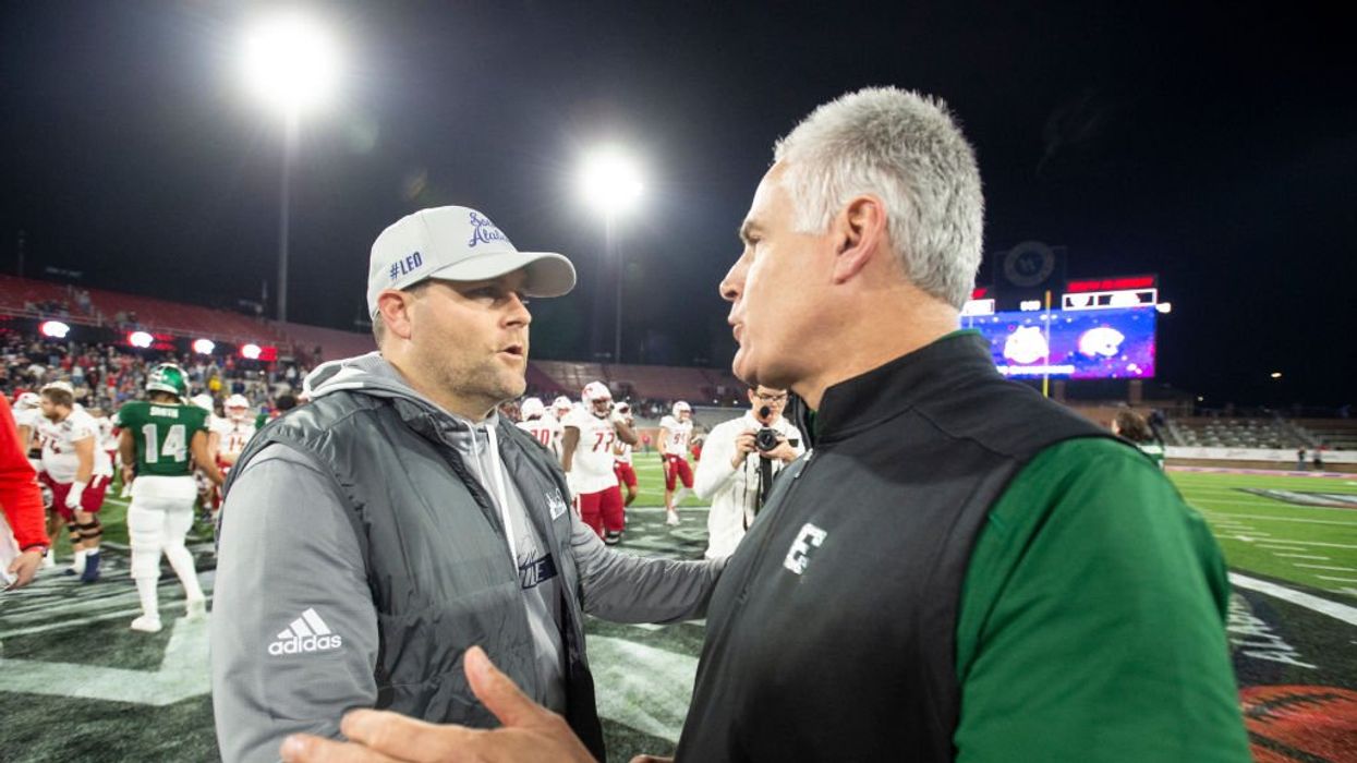 Nasty fight breaks out between college football players after losing player sucker punches winning player during postgame celebrations