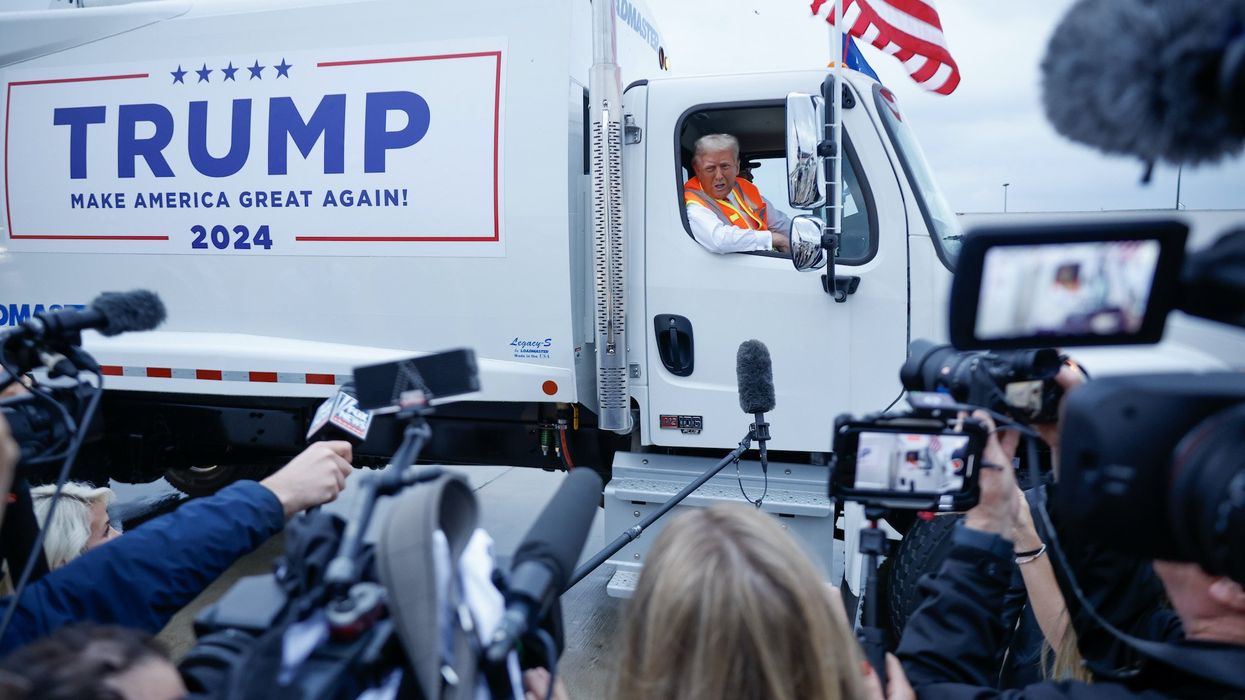 Trump runs media briefing while sitting in massive garbage truck to troll Biden gaffe