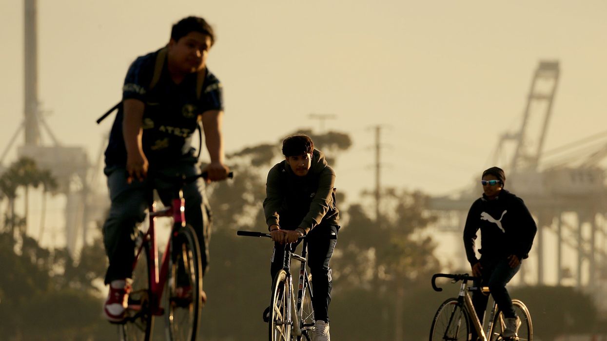 Videos show driver swerving into large group of young bicyclists who later assault the driver at parking garage