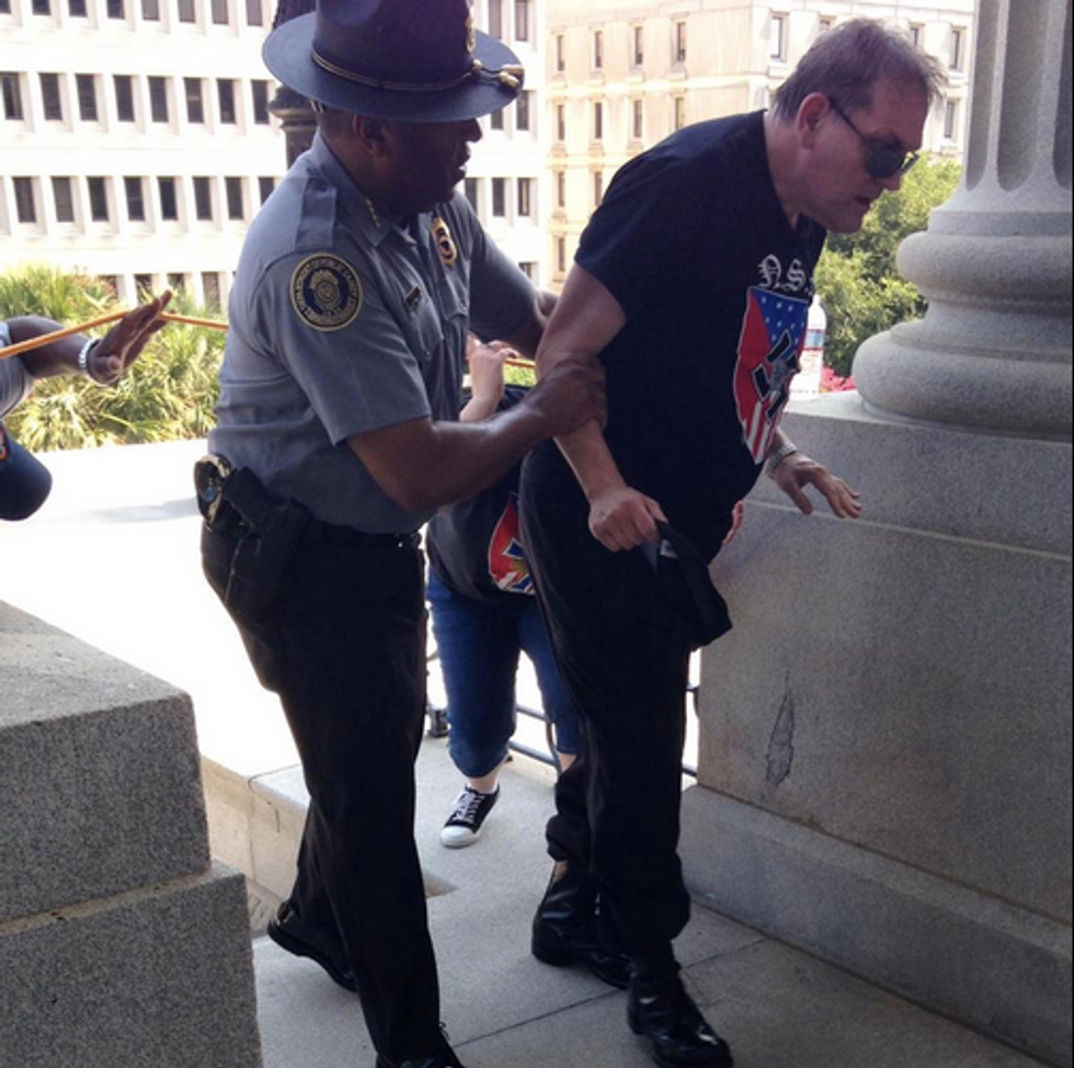 See the Powerful Photo That Captured a South Carolina Police Officer's Act of Humanity During a KKK Rally