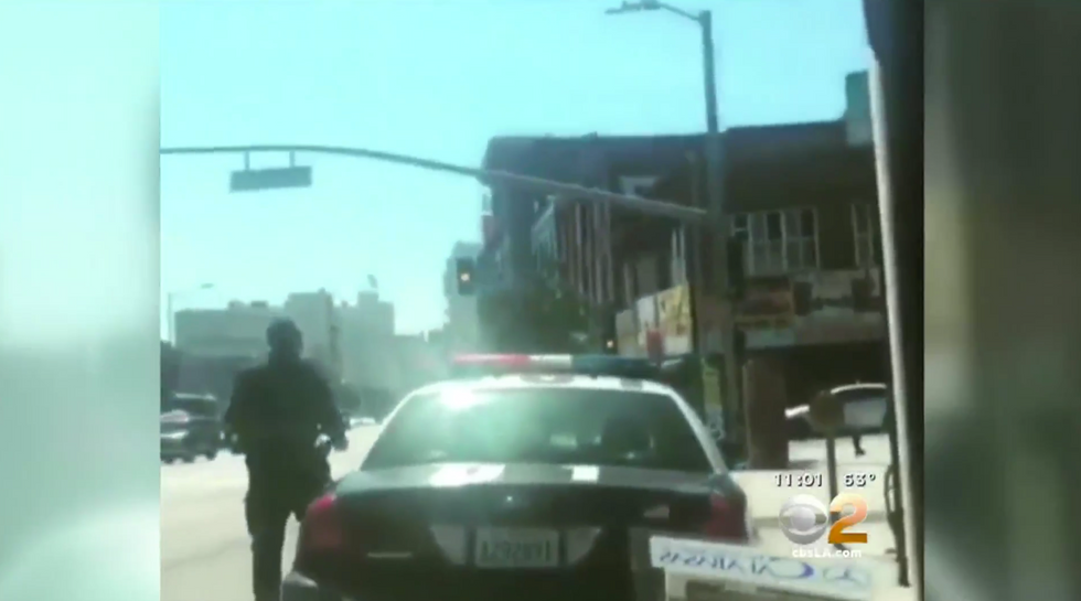 Shock Video Shows LAPD Officer Being Stalked, Man Flashing Gun (UPDATE: Arrest Warrant Issued)