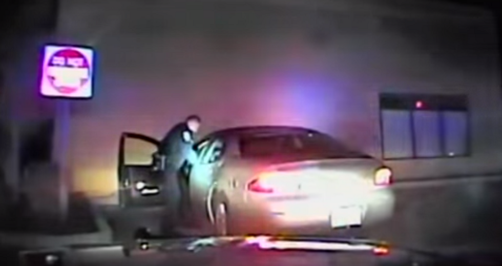 Raw Dash Cam Video: Woman Backs Car Up at High Speed With Police Officer Half-Inside, Injuring Him