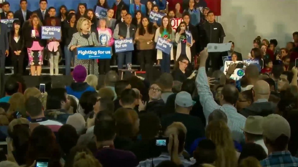 Watch How Hillary Clinton’s Security Handles Man Calmly Holding Sign Critical of Candidate During Rally