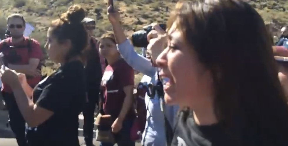 Watch Officer's Reaction After SUV Drives Past Trump Protesters Who Are Blocking It