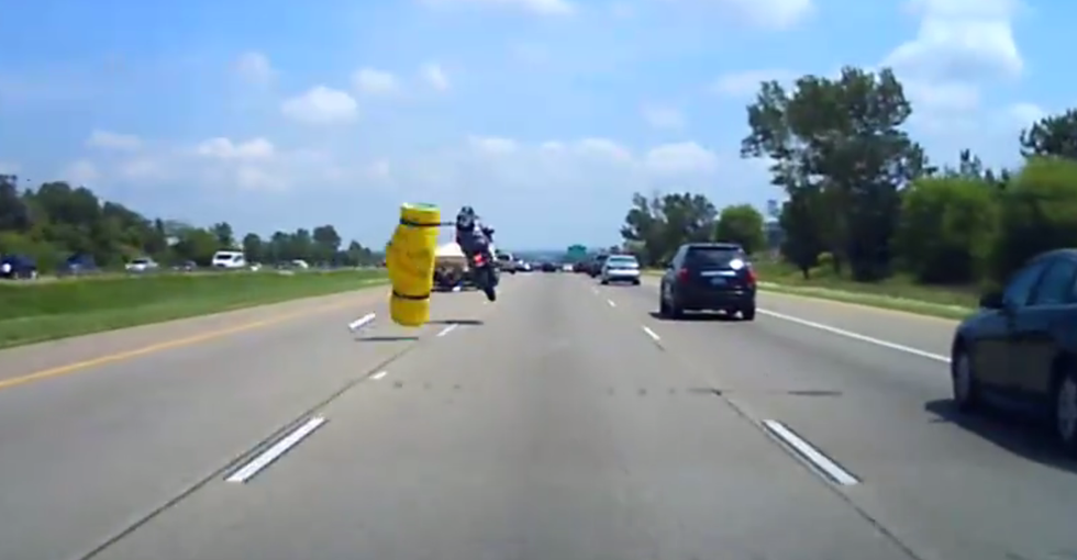 Dashcam Captures Terrifying Moment Unsecured Load Flies Off Back of SUV, Flips Motorcyclist 