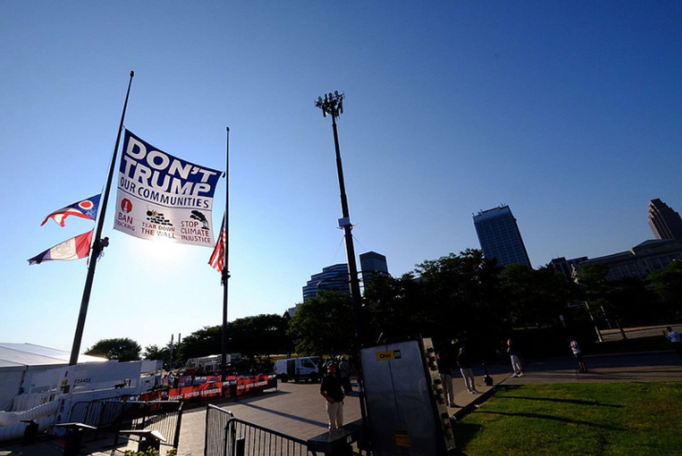 Activists Scale Flagpoles Near Convention Site to Hoist Anti-Trump Banner