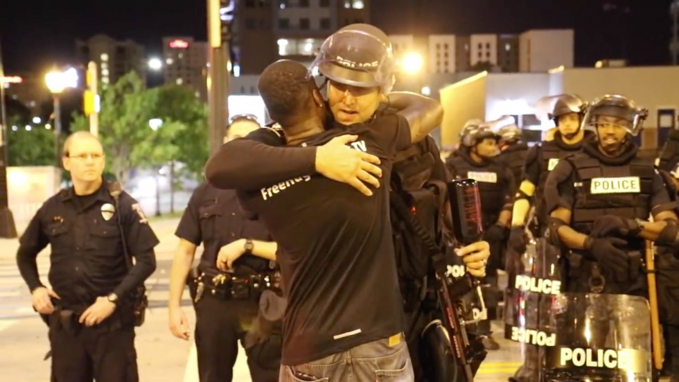Protesters accost black man as he hugs Charlotte police officers