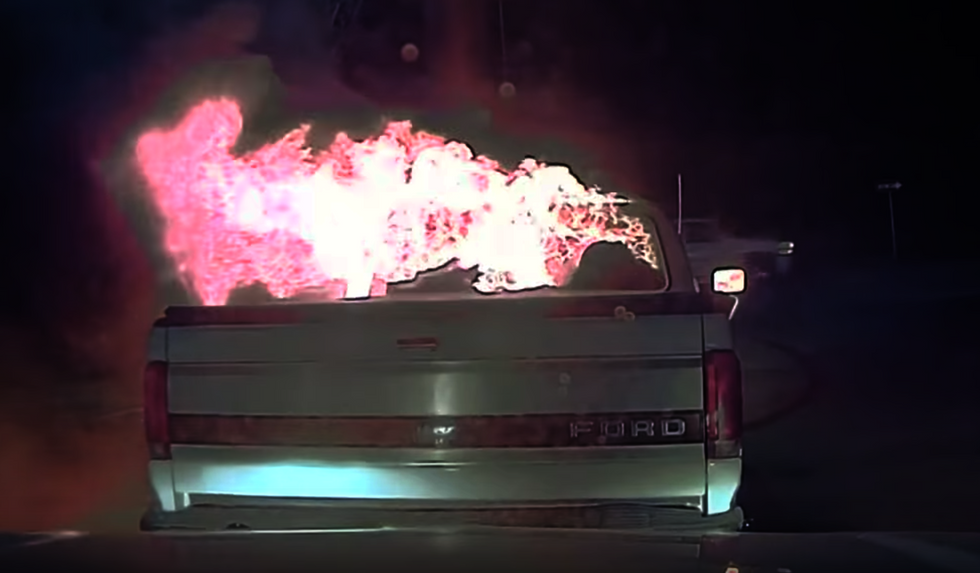 Watch: Police officer saves building by pushing burning truck away with his own patrol car