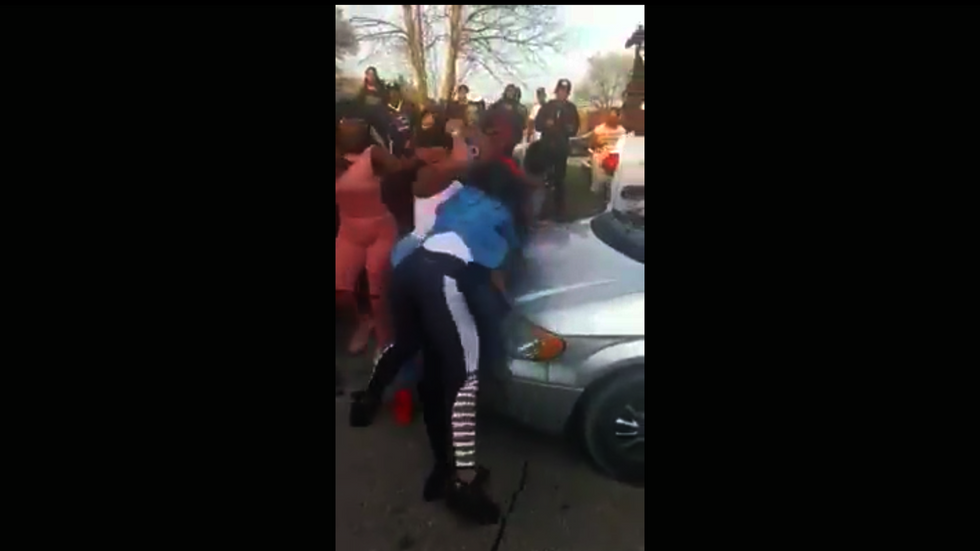 Crowd cheers and films while two women stab each other over parking spot
