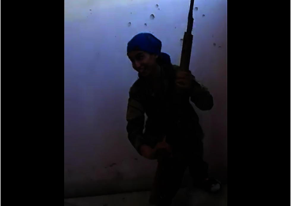 Watch: Female Kurdish sniper laughs after ISIS bullet almost takes her head