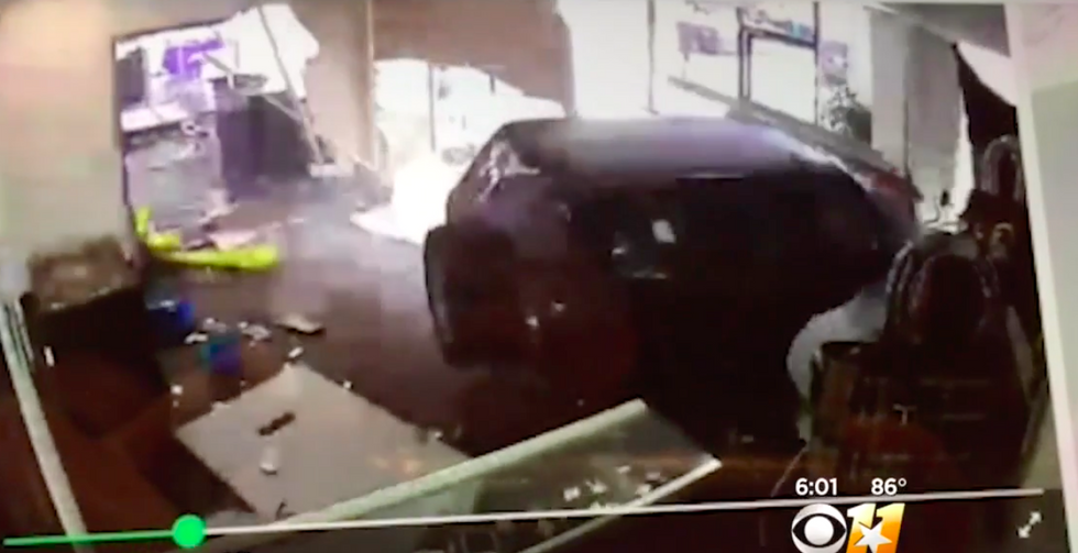 SUV crashes through a cell store, but the owner isn't upset - the reason why is crazy