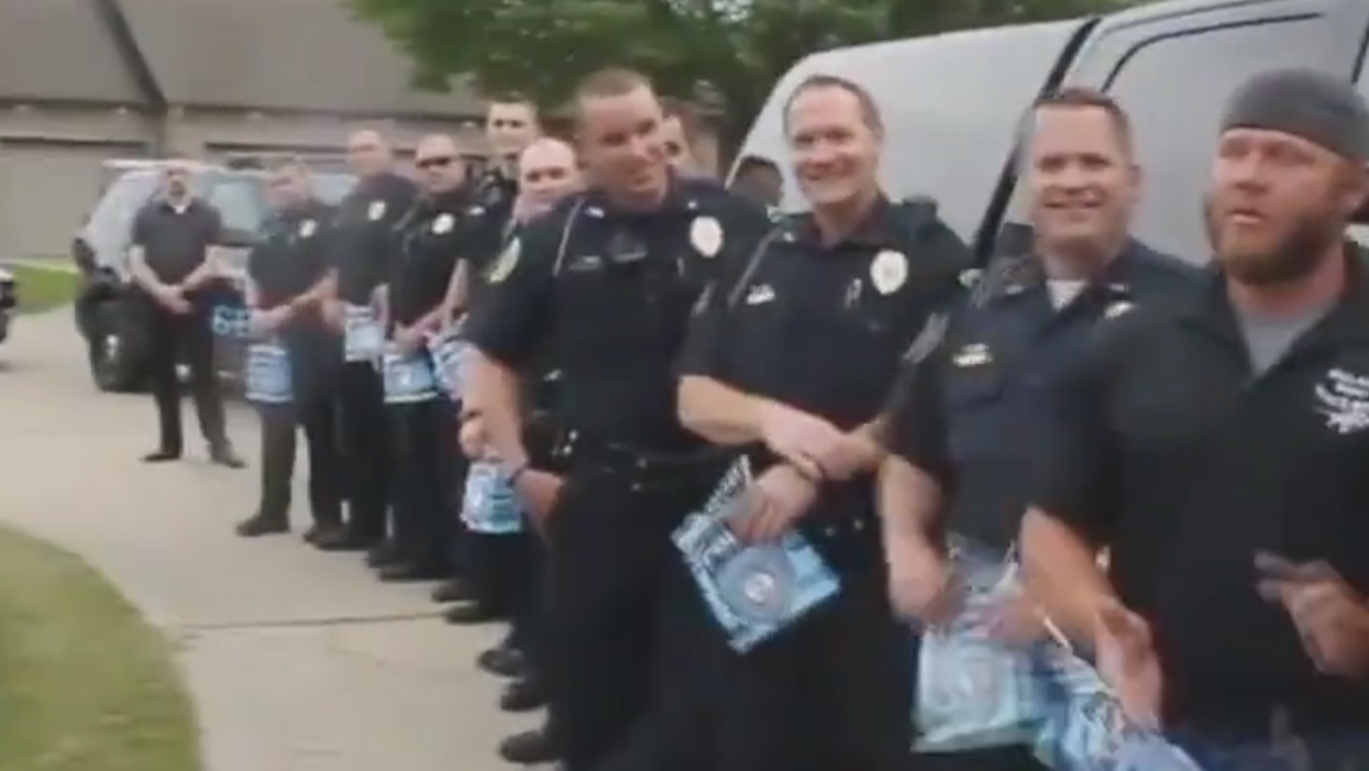 WATCH: Local police make emotional appearance at a grad party for a late officer's son