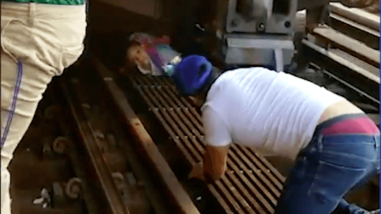 Suicidal man jumps in front of a train holding 5-year-old daughter—but she's rescued by onlookers