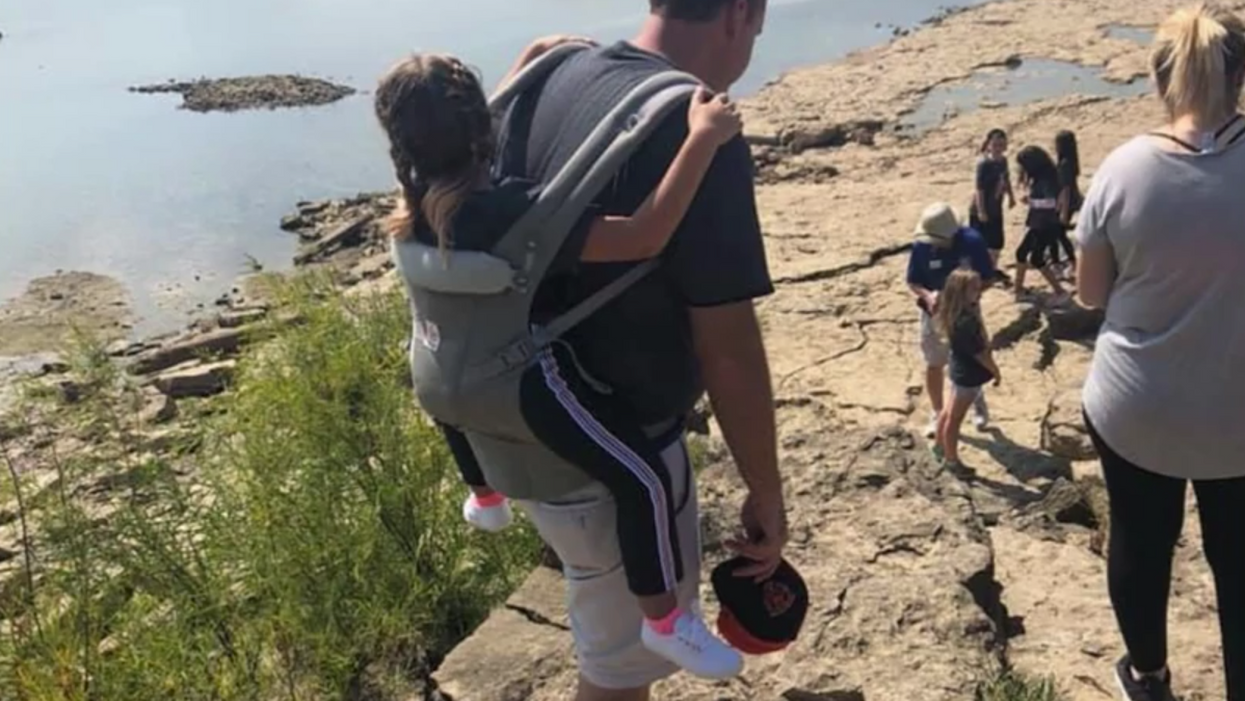 Teacher carries student with paralyzing spinal condition so she can go on an outdoor field trip