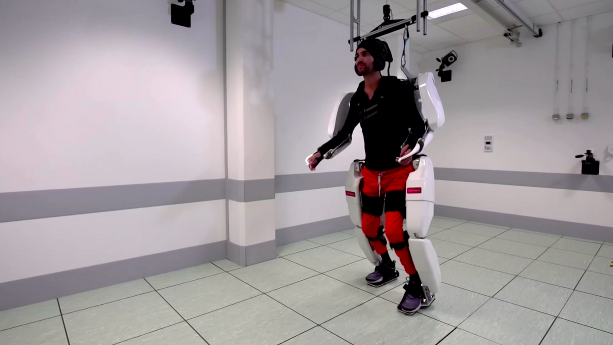 A paralyzed man was able to walk across a room with the help of an exoskeleton guided by his own brain