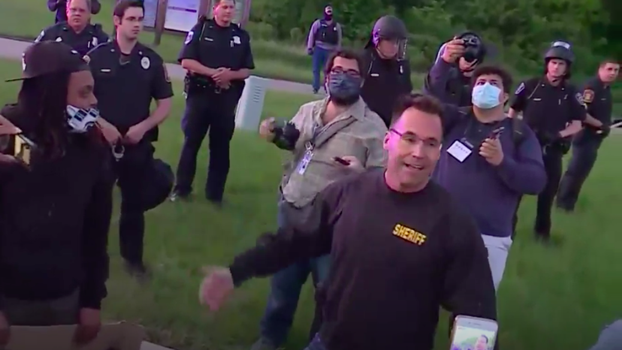 A sheriff marching with protesters in Flint was among the hopeful images from a violent, destructive weekend