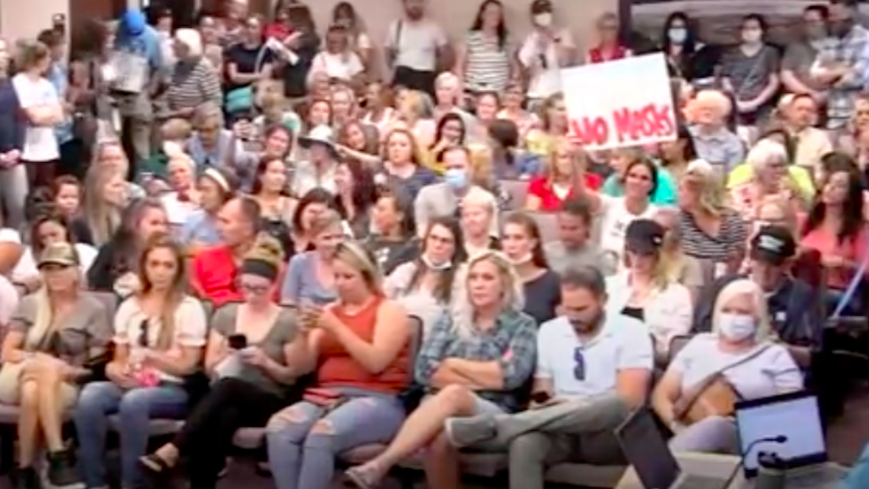 Utah parents protest state mask mandate for students by not wearing masks to crowded meeting
