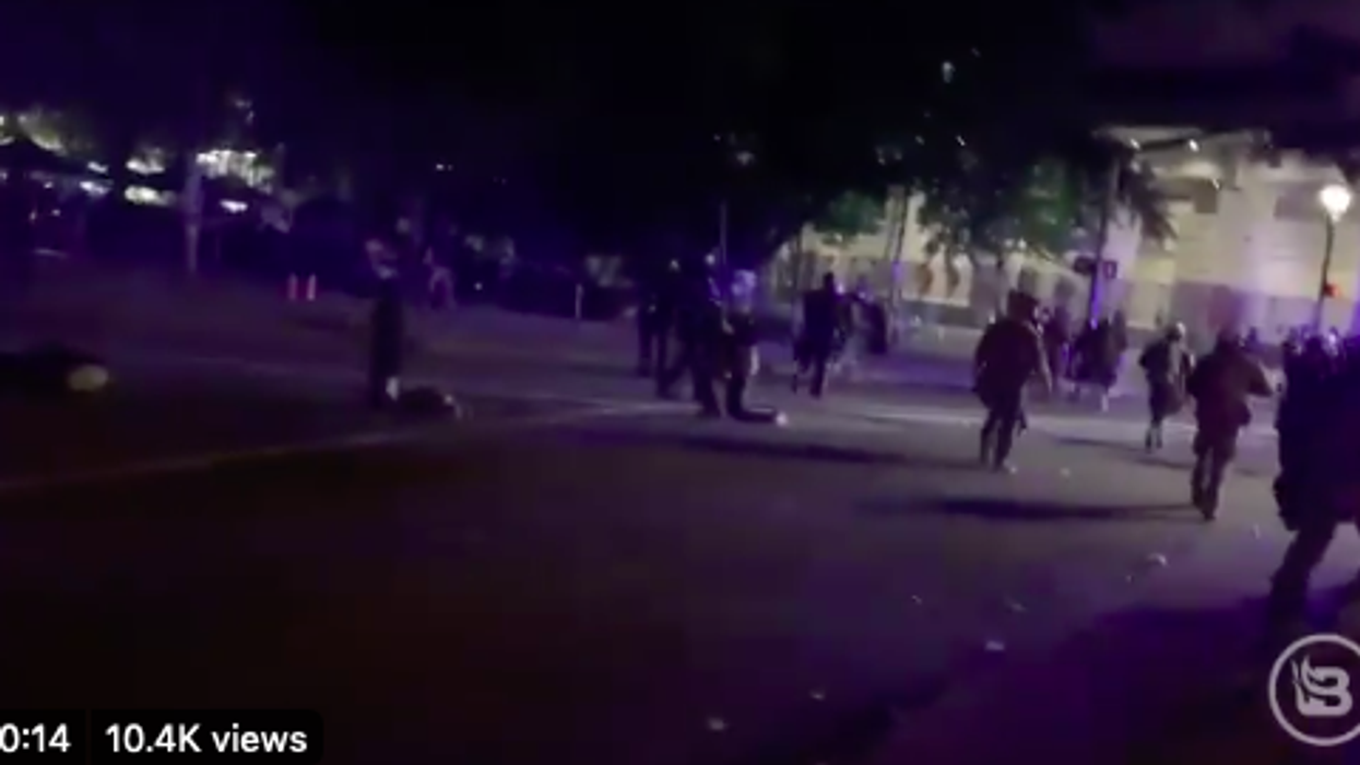 MEDIA TRICKS: Portland protester and photographer appear to stage an arrest for a photo-op