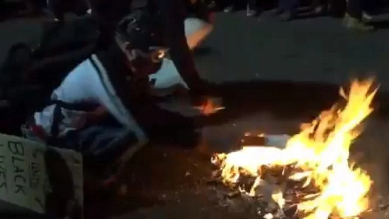 Protesters burn Bibles and American flags in Portland