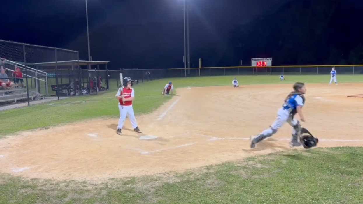 Disturbing video shows kids, parents ducking for cover as bullets fly at youth baseball game — and police say gunfight had 'nothing to do' with the game