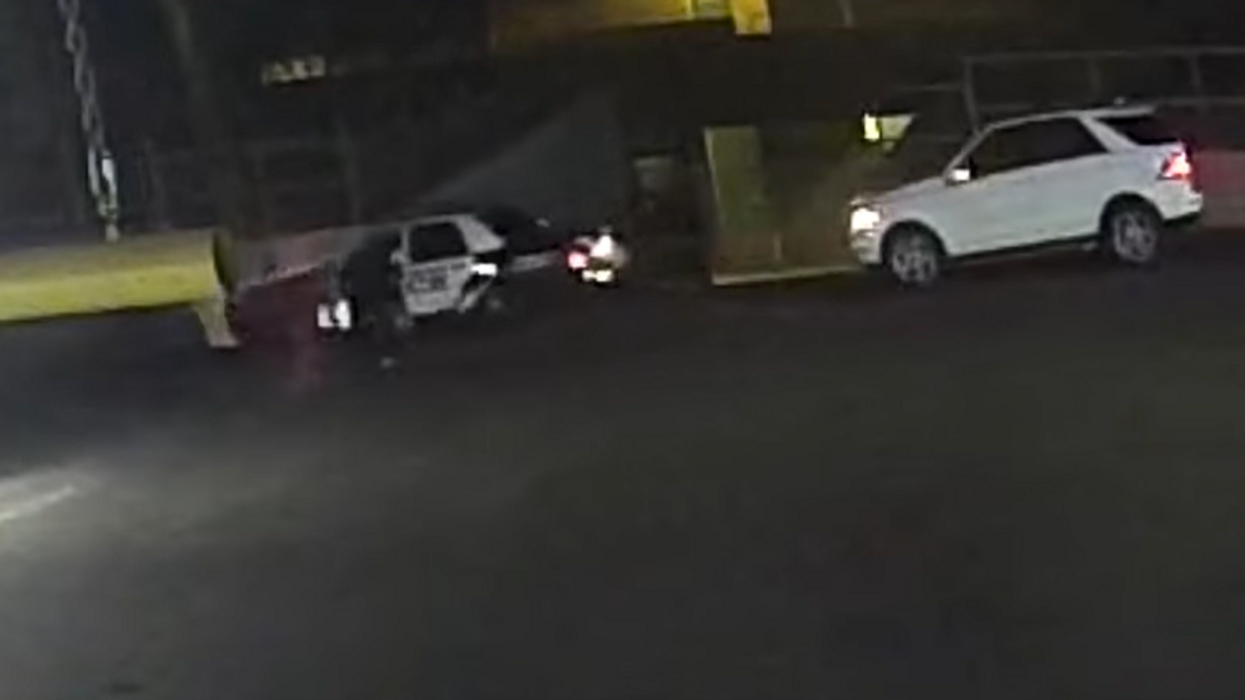 Wild video shows woman ram cop cruiser to infiltrate police headquarters, officer barrel rolls out of car to fire on suspect who said the Illuminati was trying to kill her