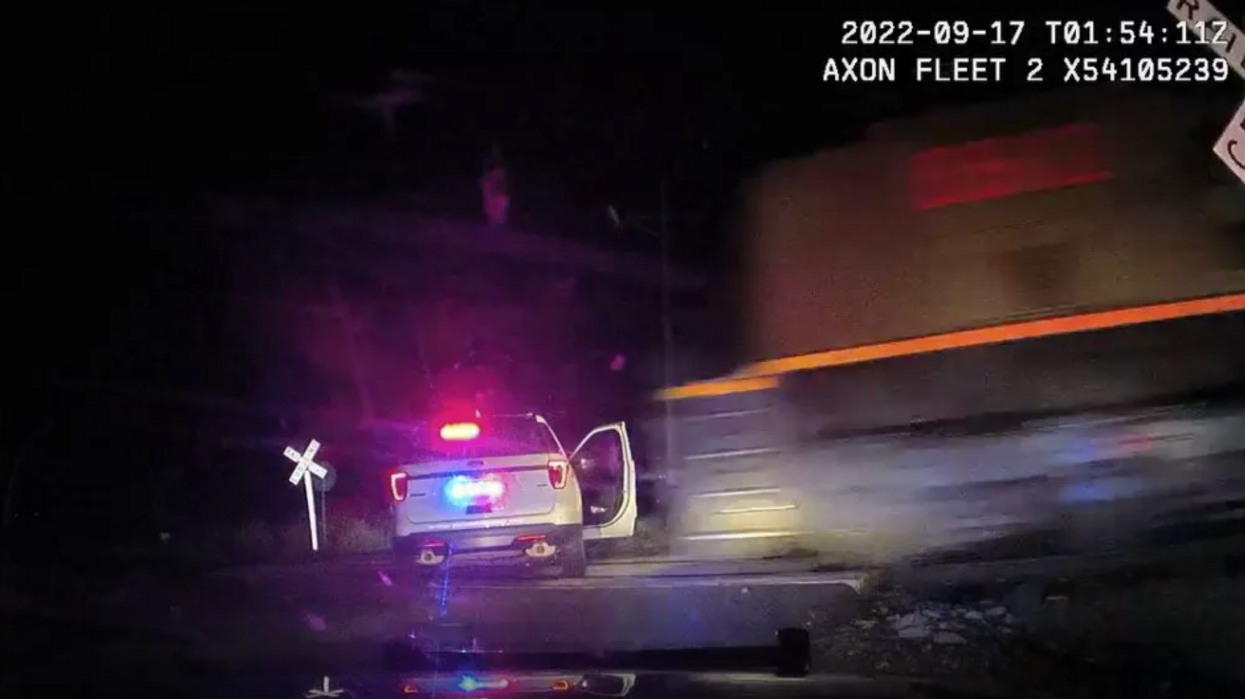 Dramatic video shows the moment freight train plows into police vehicle with woman handcuffed inside, officer placed on administrative leave