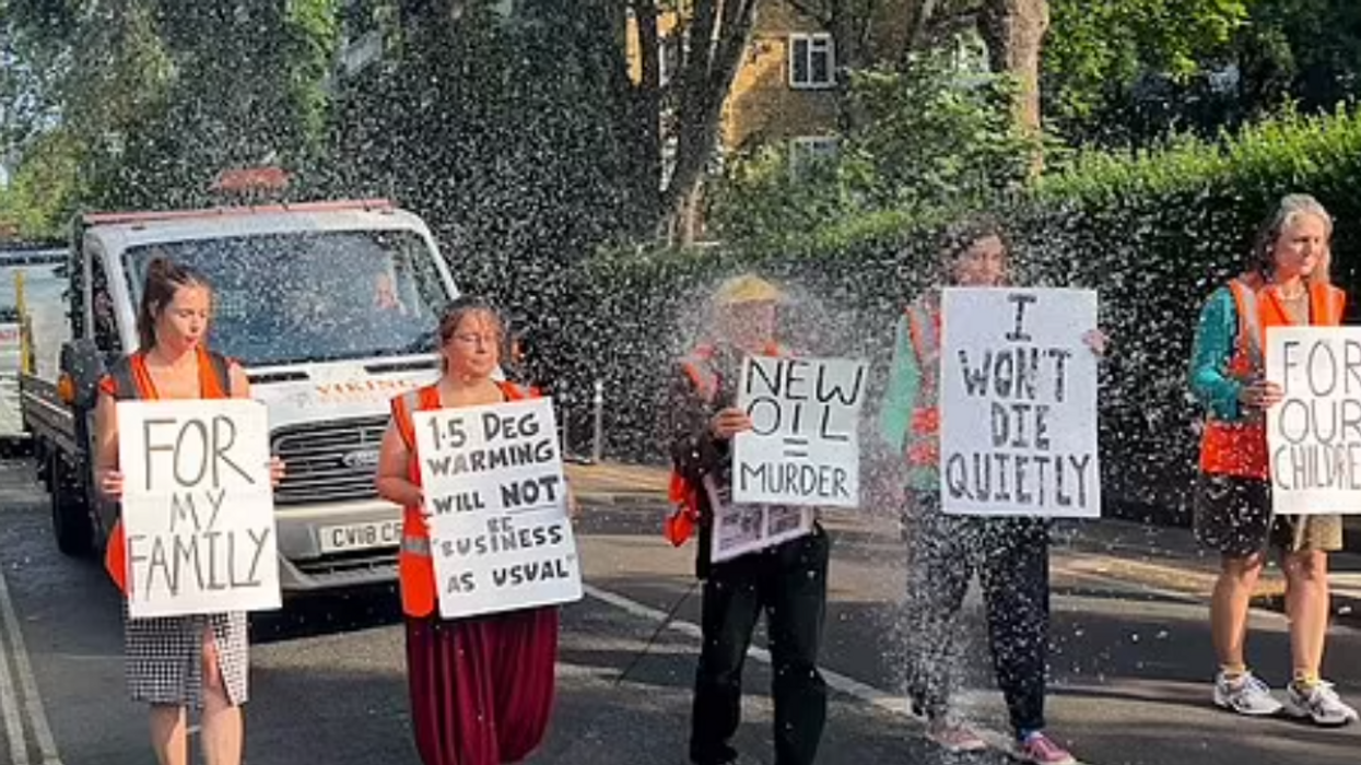 Anti-oil activists drenched in water by angry resident after protest blocks highway in UK town