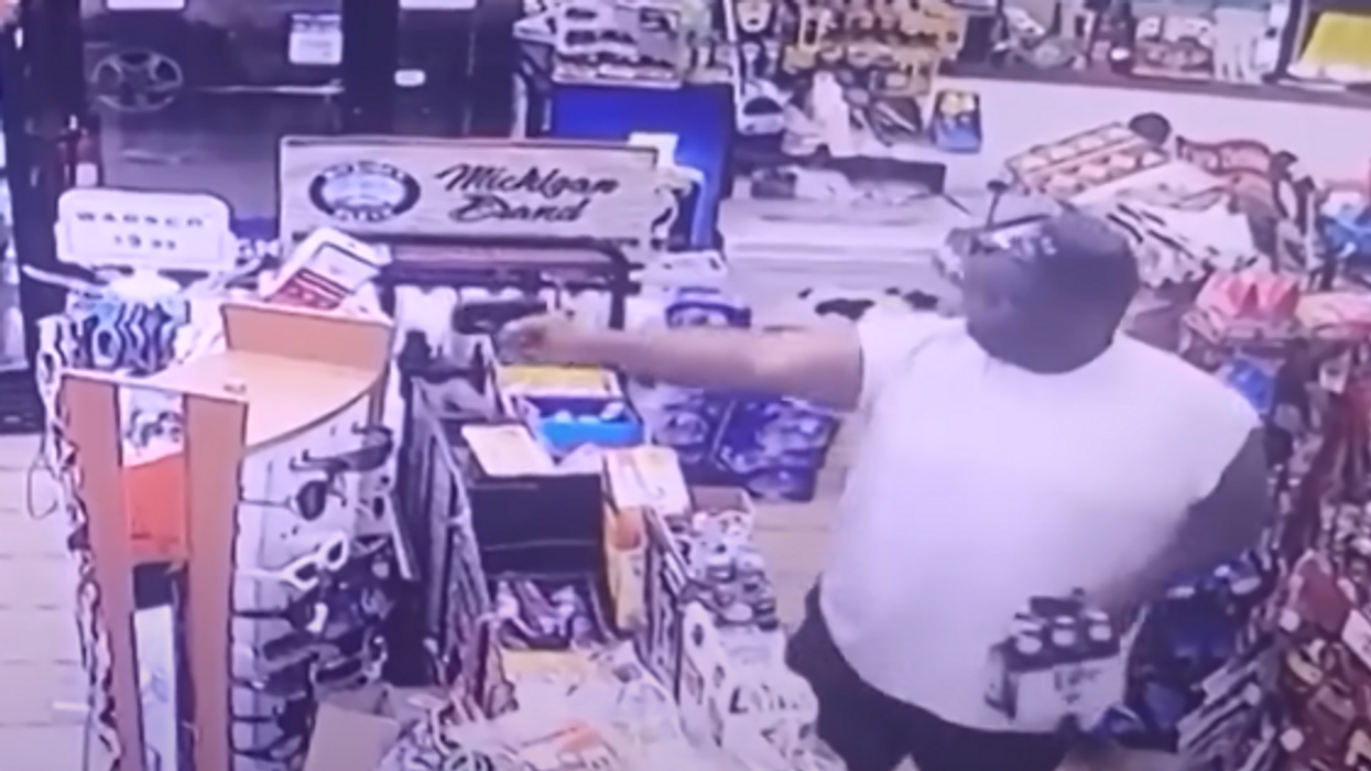 Video shows the moment hero customer guns down robber while holding a six-pack of Miller Lite beer