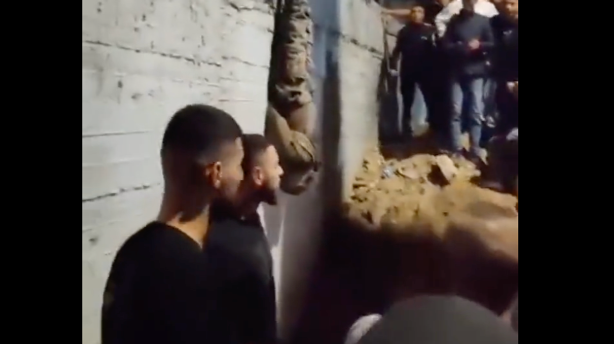 'Israel spies' killed and strung up on electrical pole as mob in West Bank cheers