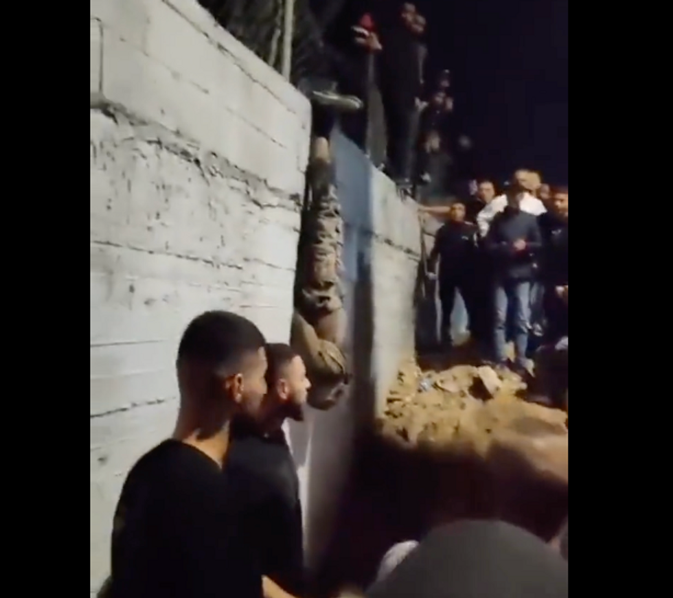 'Israel spies' killed and strung up on electrical pole as mob in West Bank cheers