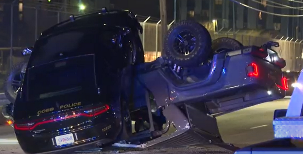 Atlanta police chase ends with cop car on top of suspect's crushed‚ overturned Jeep