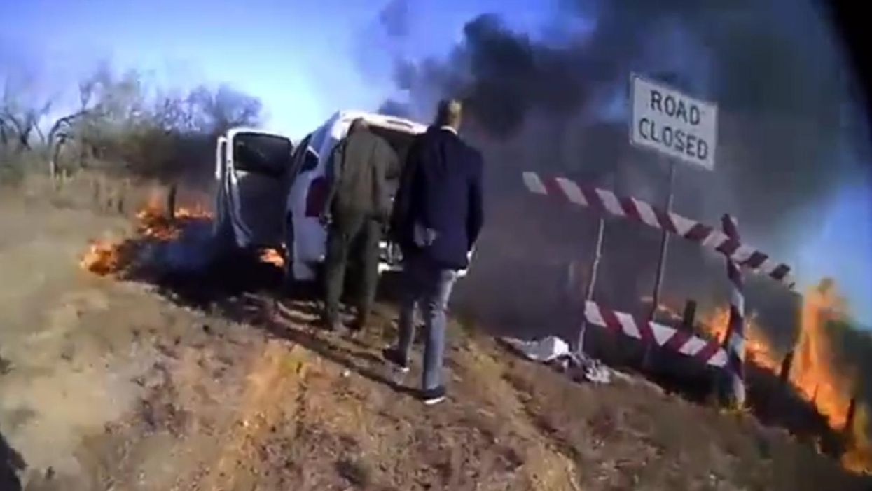 Incredible video shows police officers saving migrant woman stuffed in duffel bag from fiery car wreck
