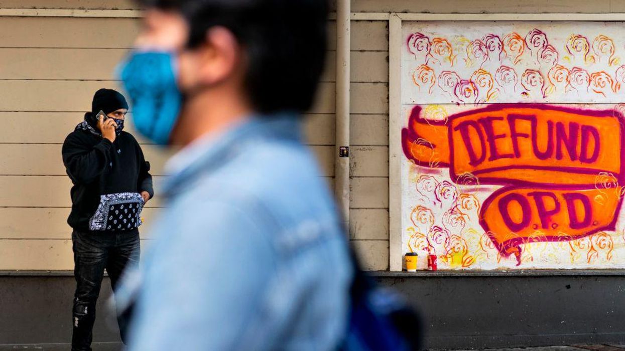 'Irony defined': Only days after Oakland slashed its police budget, armed robbers ran up on the city's woke 'violence prevention' chief while he discussed rising crime with local news reporters