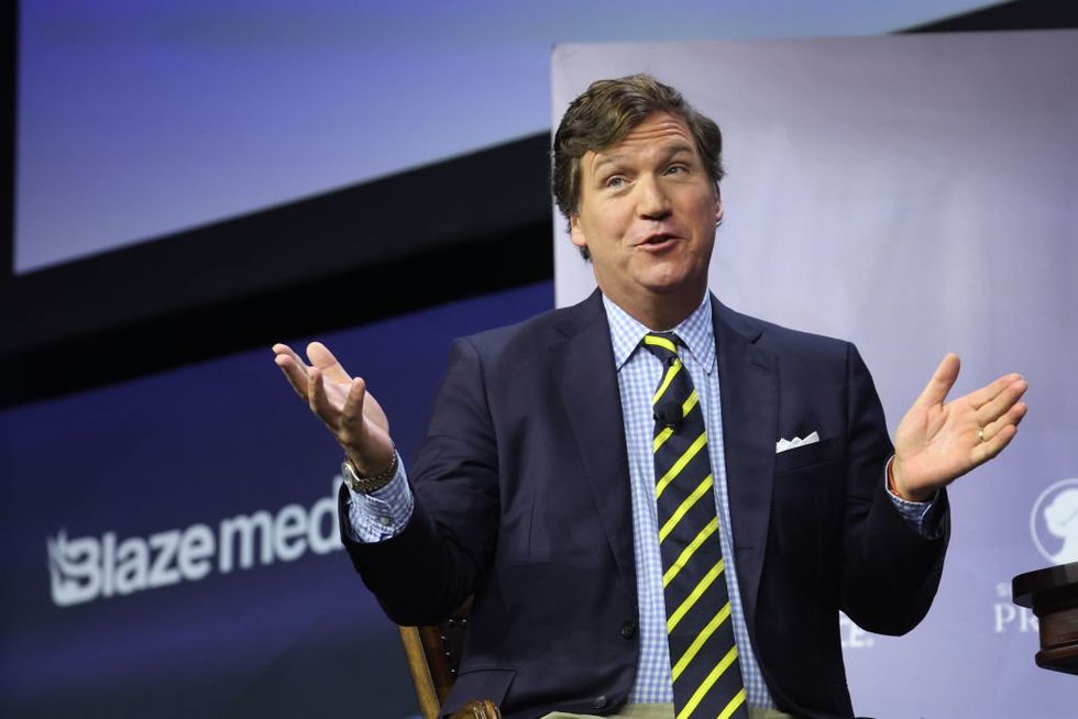 Journalist arrested‚ hit with 14 federal crimes for allegedly hacking‚ leaking Fox News Tucker Carlson content