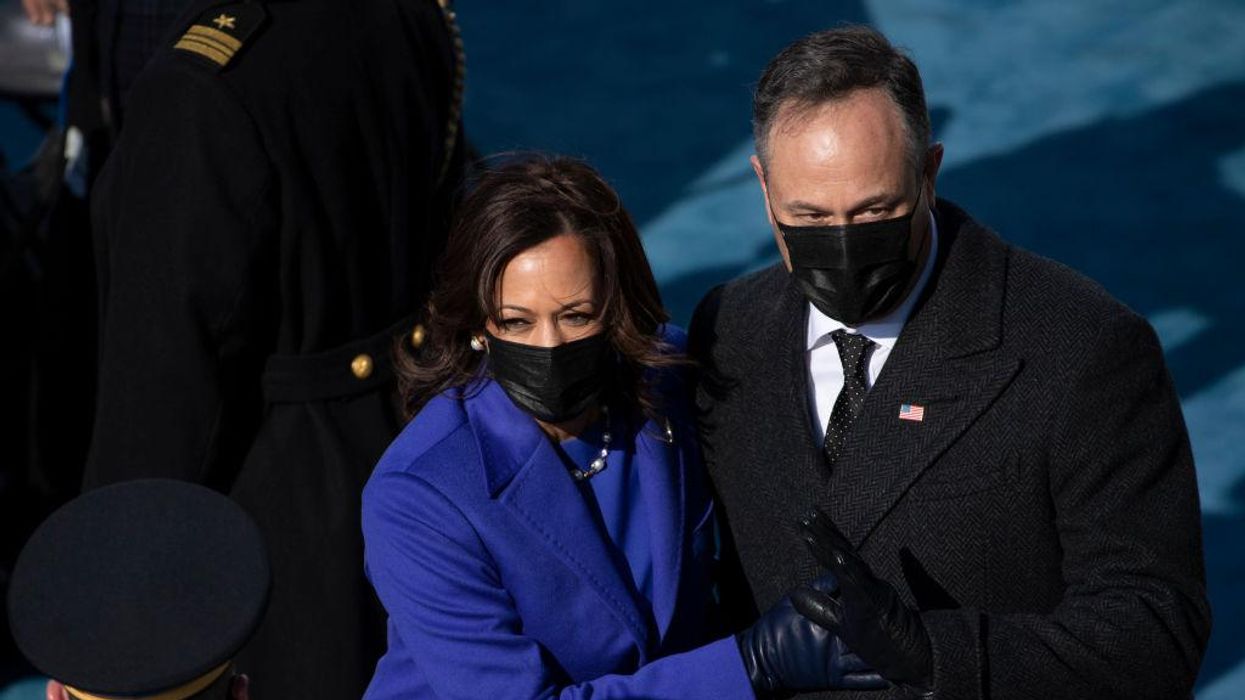 Kamala Harris and husband Doug Emhoff kiss with masks on despite being vaccinated and outside. It's just the latest confusing mask gesture by the Biden admin.